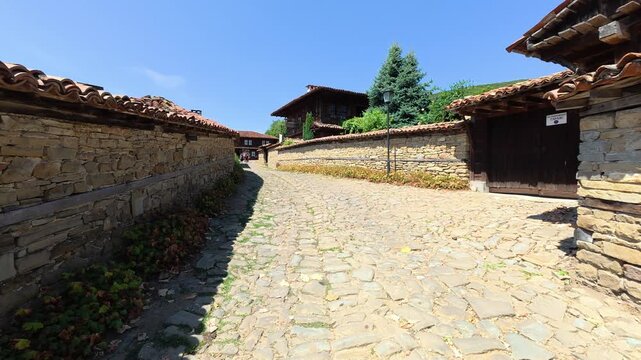Traditional wooden houses in the historic village of Zheravna, Bulgaria. Authentic Balkan architecture with cobblestone street and rustic details