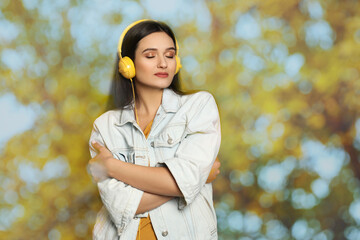 Woman listening to sounds of nature which making her feel calm. Double exposure with tree