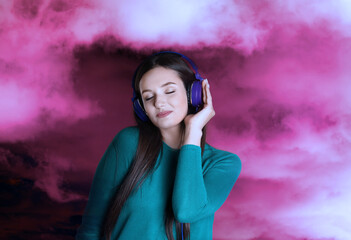 Woman listening to sounds of nature which making her feel calm. Double exposure with clouds