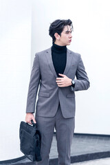 Stylish businessman walking with a briefcase in an urban outdoor setting. A variety of businessmen's gestures.
