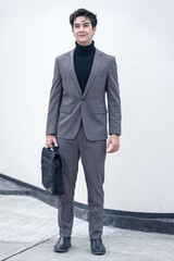 Stylish businessman walking with a briefcase in an urban outdoor setting. A variety of businessmen's gestures.