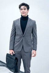 Stylish businessman walking with a briefcase in an urban outdoor setting. A variety of businessmen's gestures.