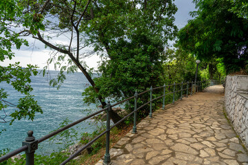 Stone seaside path Lungomare with railing along Adriatic coast in Opatija, Croatia