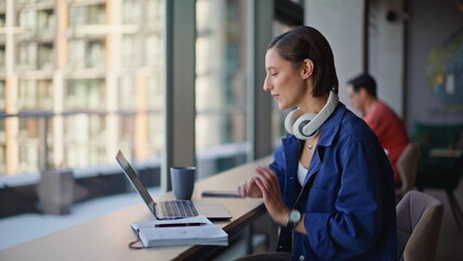 Smiling freelancer video calling in cafeteria closeup. Woman greeting to laptop
