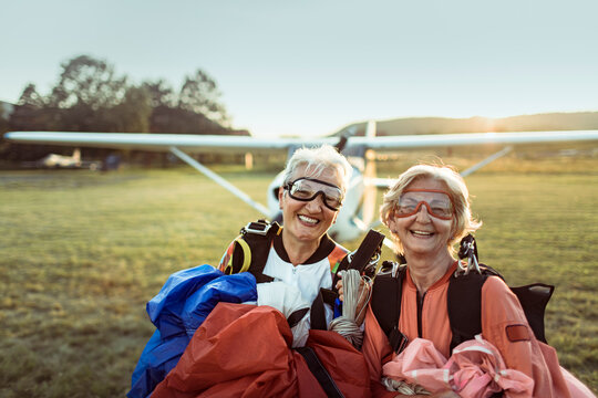Senior women skydivers smiling