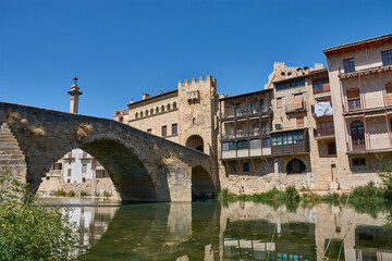 Fototapeta premium The majestic stone bridge of Valderrobres, Teruel, over the Matarraña River, guarding the entrance to the medieval town
