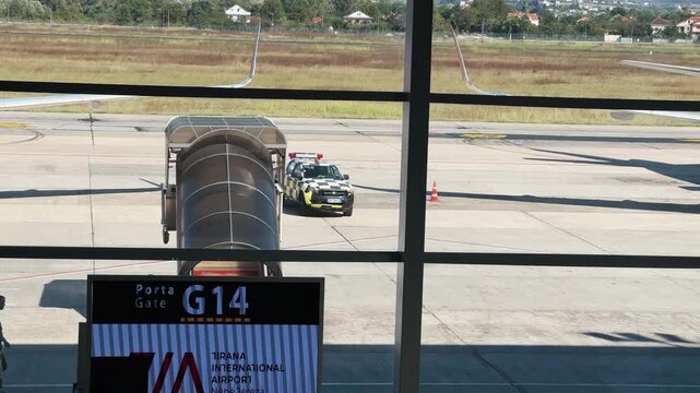 Support vehicle drive on boarding gate at Tirana International Airport during daytime
