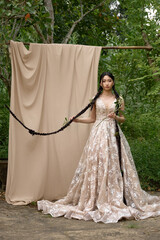 Fototapeta premium Female model in lace dress outdoors smiling.