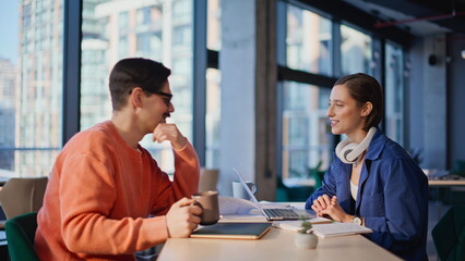 Positive coworkers enjoy communication at creative agency workspace closeup. 