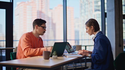 Frustrated employees finding mistake in business project sitting office closeup.