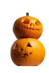 Two creatively carved Halloween pumpkins stacked together, isolated on white background, vertical, a skull design on top and a classic jack-o'-lantern face below, showcasing festive autumn decorations