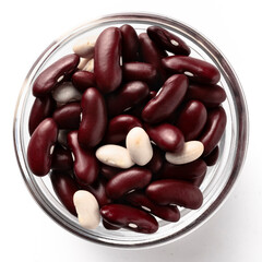 High-resolution top view of uncooked mixed white and red beans in a transparent glass bowl isolated on a white background.