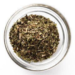 High-quality closeup image of dried basil leaves in a transparent glass bowl on a white background, viewed from above