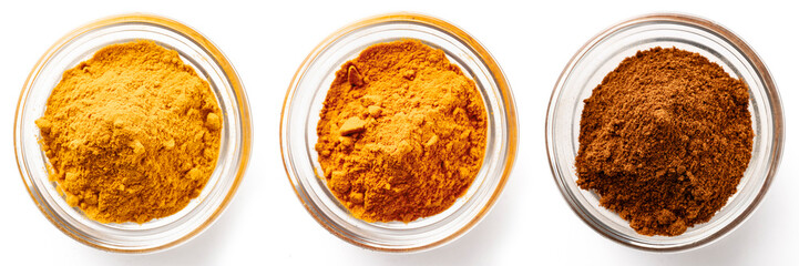 High-quality closeup image of three different ground spices in transparent glass bowls on a white background, top view.