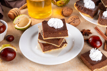 Homemade autumn taste chestnut pie bars. Freshly baked chestnut bars with whipped cream on it, with...