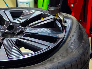 The car tire is being changed on a tire removal and installation machine. © Pamir