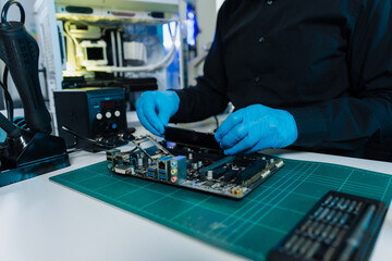 Hands repairing electronic devices. Electronic technician.