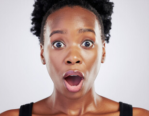 Studio portrait of a surprised woman on white background