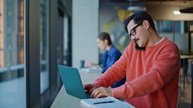 Talented project manager calling cellphone writing in notebook at cafe closeup. 
