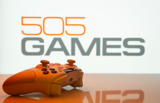 Dhaka, Bangladesh- 23 Sep 2025: Game controller in front of 505 Games logo on a background.