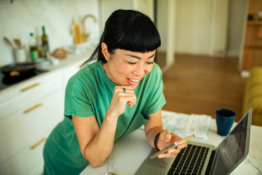 Woman using smartphone at home