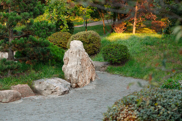 sunny vivid bright spring season nature landscape local nature place with stone rocks garden and green foliage plants in April day