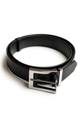 A simple, black leather belt with a silver buckle lies coiled on a white background.  The belt is narrow and appears to be made of smooth leather