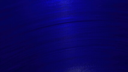deep cobalt blue abstract texture with curved brush strokes and subtle light reflections for modern...
