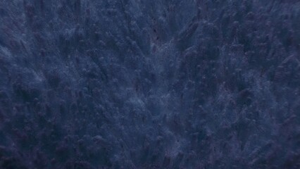 dark blue marbled stone texture with soft fiber patterns and moody abstract depth for wallpaper or modern banner background