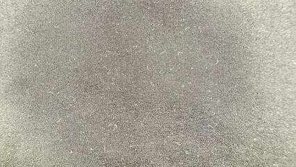 close-up of textured dark grey fabric with subtle weave and soft grain pattern suitable for backgrounds, textile design, or commercial use