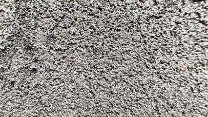 textured metallic surface with intricate pattern of holes and reflective shine suitable for modern wallpaper or commercial background