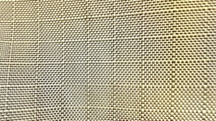 close-up woven fabric texture with subtle geometric pattern for wallpaper or editorial design use