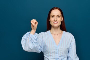 Red-haired language teacher engaging students with sign language lesson
