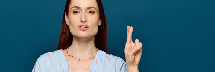 Language teacher with red hair demonstrates sign language in a blue setting
