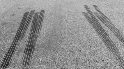 Black tire marks on road, Black rubber tire marks and tread marks, Tire trace track wheels texture and background, Auto tire tread grunge, Car wheel tyre tread track black tyre print.