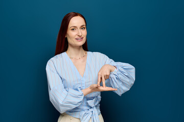 Red-haired language teacher engaging students in sign language lessons