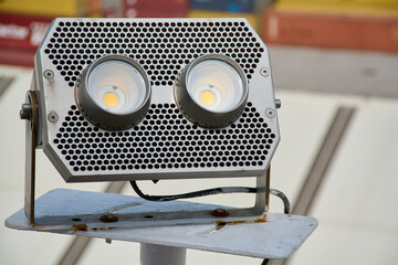Close up of an industrial projector with LED technology, designed for powerful and efficient lighting in outdoor work environments.