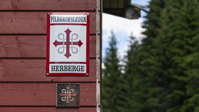 Waymarker Olav's Cross for pilgrims, pilgrims' hostel in the forest, near Eidsvoll, Norway