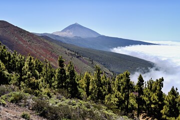 Volcanic landscape, behind volcano Pico del Teide above trade wind clouds, Teide National Park, Tenerife, Canary Islands, Spain