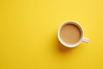 A white coffee cup filled with light brown liquid sits centered on a bright yellow surface