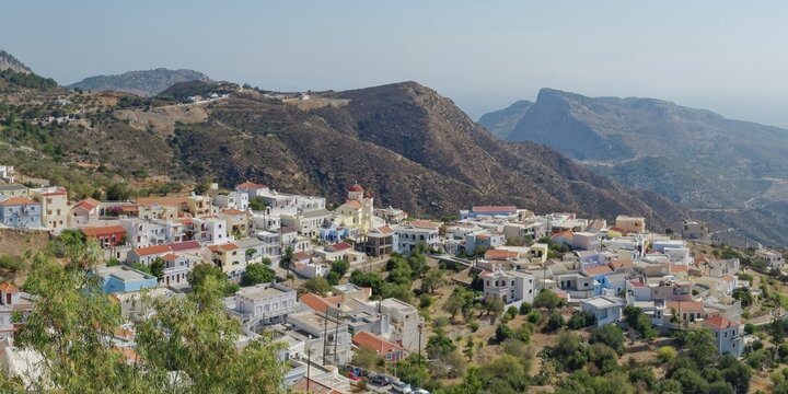 Small houses of the village of Othos embedded in green, hilly landscape, hike from Pyles to Othos, Pyles, Othos, Karpathos, Greece