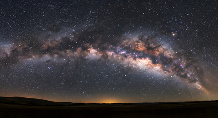 Fototapeta premium Vibrant Milky Way Across Dark Night Sky Above Landscape