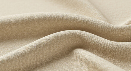 Close-up of soft, beige fabric with gentle folds and subtle texture, creating a warm and inviting surface.
