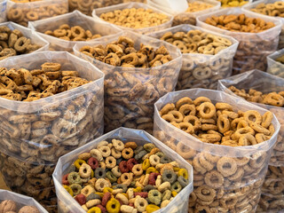 Traditional italian snack Taralli crackers from Apulia region with different flavours in plastic bags on a local market
