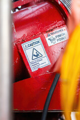 "Pinch point warning sign" hand and finger injury prevention alert that showed on the industrial equipment such as blender, pumping or milling machine. Safety sign in unsafe working place, close-up.