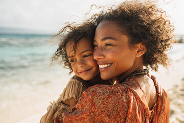 Black Woman Carrying Child on the Beach, Smiling Together