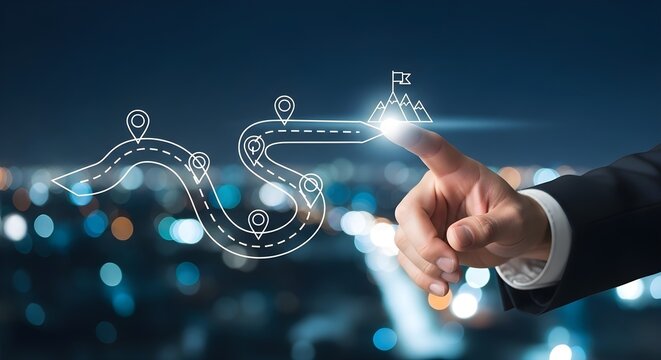 A businessman's hand touches a digital illustration of a path leading to a mountain peak, symbolizing goals and success.