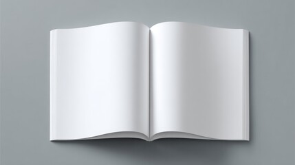 Open book showing two blank pages, lying on a gray surface in a simple, top-down shot