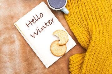 Hello Winter Cozy Morning With Notebook, Cookies, Mug, And Yellow Knit Blanket