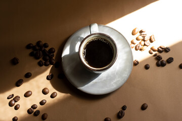 Coffee Cup On Saucer With Coffee Beans Under Warm Morning Light
